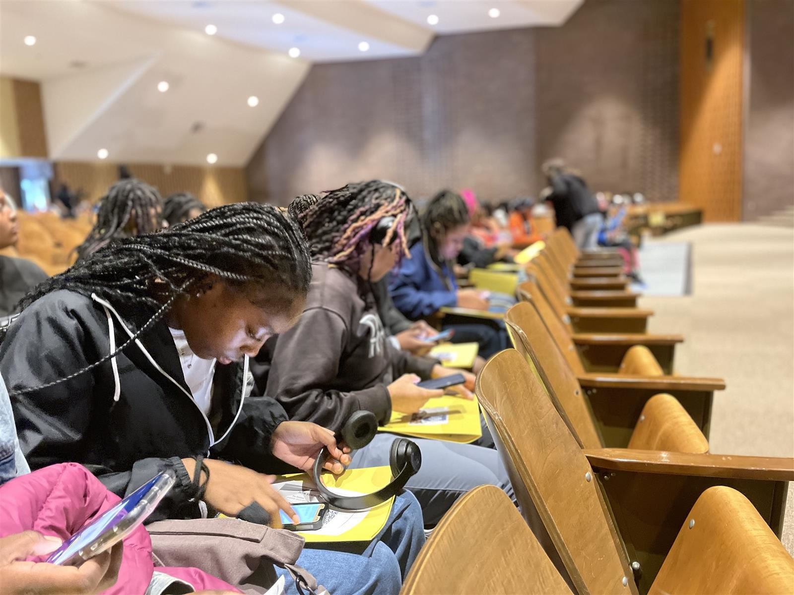 Students focus in on questions during the on-line survey at the Teen Summit.